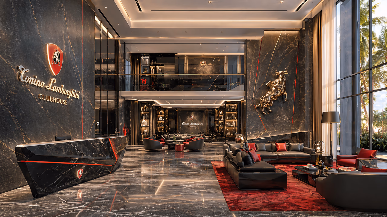 The Tonino Lamborghini Clubhouse — black marble double-height arrival lobby with branded reception, gold bull statue, and lounge seating in red and black.