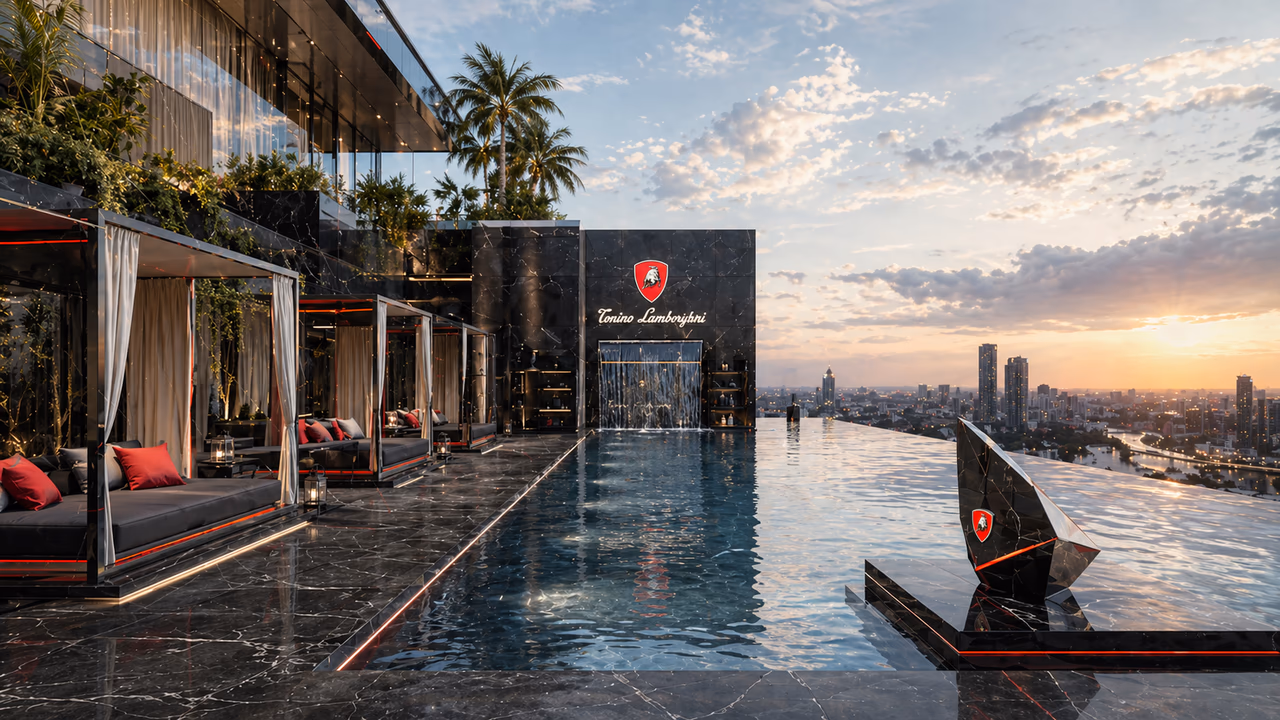 The rooftop infinity pool at sunset — branded pool wall, cabanas with red cushions on the long edge, and the Gurugram skyline beyond.