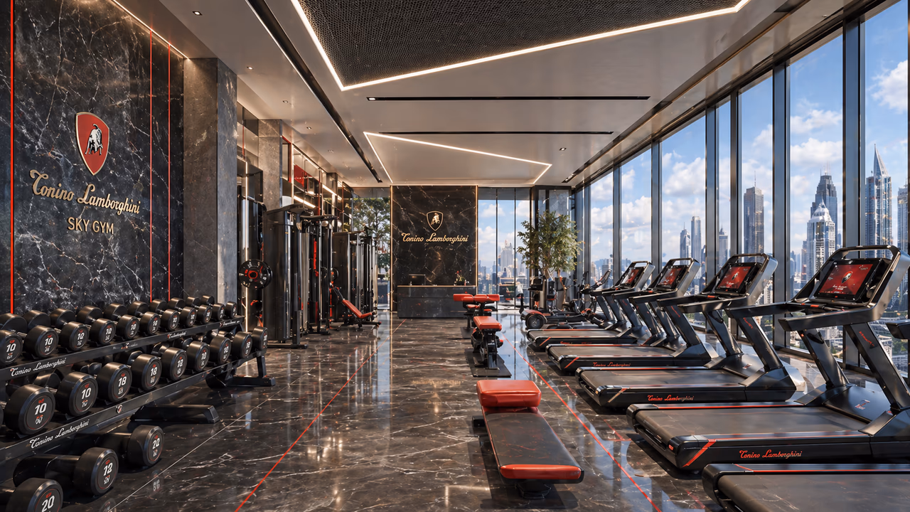 The Tonino Lamborghini Sky Gym — branded marble feature wall, a row of treadmills against floor-to-ceiling glass with skyline views, and a dumbbell rack along the far wall.